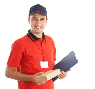 Delivery man holding small parcel box and clipboard in studio.
