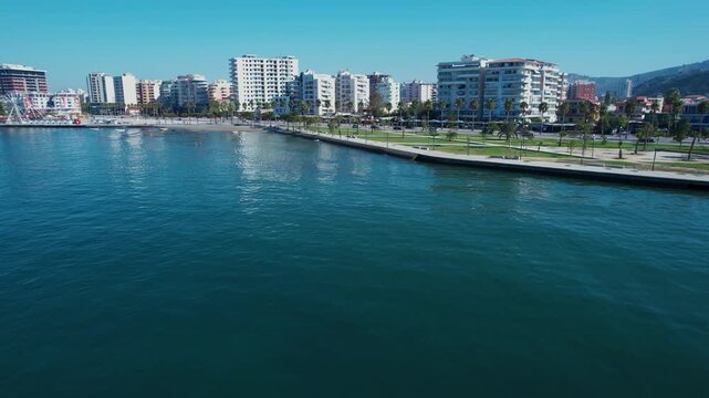 Quiet sea waves gently washing the panoramic Lungomare promenade during a bright summer morning