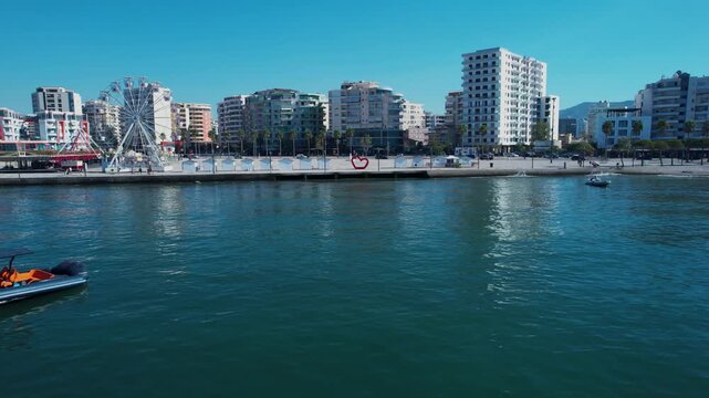 Morning light shines over seaside boats resting on calm harbor of Vlora in Albania