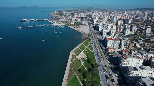Scenic Vlora seashore showcases port and the vibrant Lungomare promenade decorated with trees