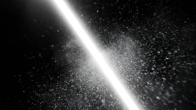 Bright laser beam cutting through particle cloud with shining light on black background in cinematic studio