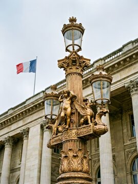 Ornate French Street Lamp With Cherubs in Front of Government Building