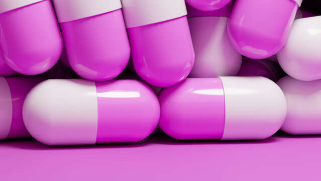 Medication capsules with white and pink halves stacked closely