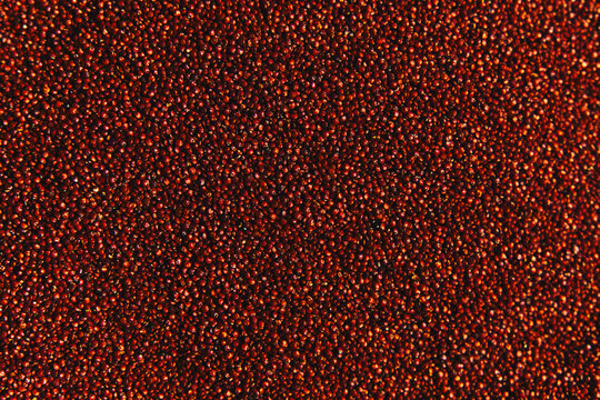 Organic red quinoa seeds background texture macro view