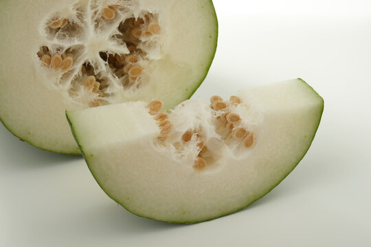 fresh winter melon slice showing white flesh and seeds