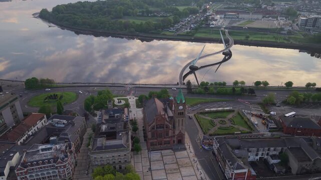 Aerial view of the Peace Bridge and the historic Guildhall building spanning the River Foyle in Derry, Northern Ireland, United Kingdom.