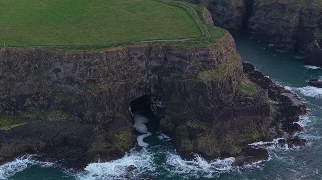 Aerial view of the dramatic basalt cliffs and sea cave at Giant's Causeway in Bushmills, Northern Ireland, United Kingdom.