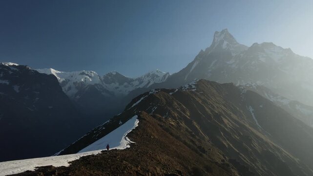 Drone footage of hikers walking along a mountain ridge at Mardi Himal, Nepal, with the iconic Machhapuchhre, or Fishtail Mountain, rising in the background.
