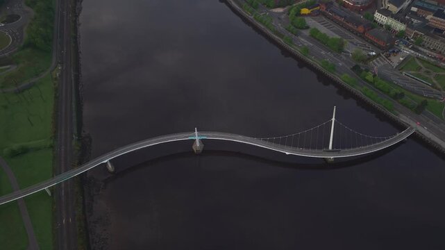 Aerial view of the Peace Bridge spanning the River Foyle in Derry, Northern Ireland, United Kingdom.