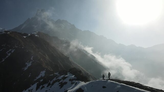 Drone footage of hikers walking along a mountain ridge at Mardi Himal, Nepal, with the iconic Machhapuchhre, or Fishtail Mountain, rising in the background.