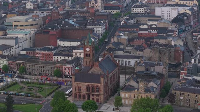 Aerial view of the historic Guildhall building surrounded by urban streets and rooftops in Derry, Northern Ireland, United Kingdom.