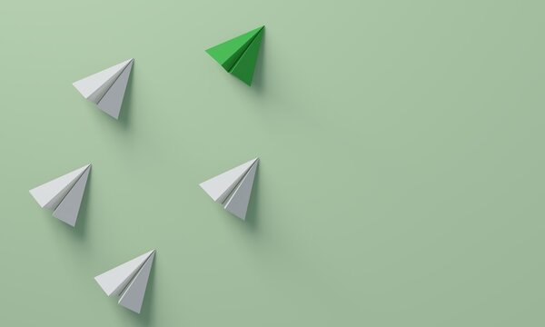 Green paper plane leading white planes forward