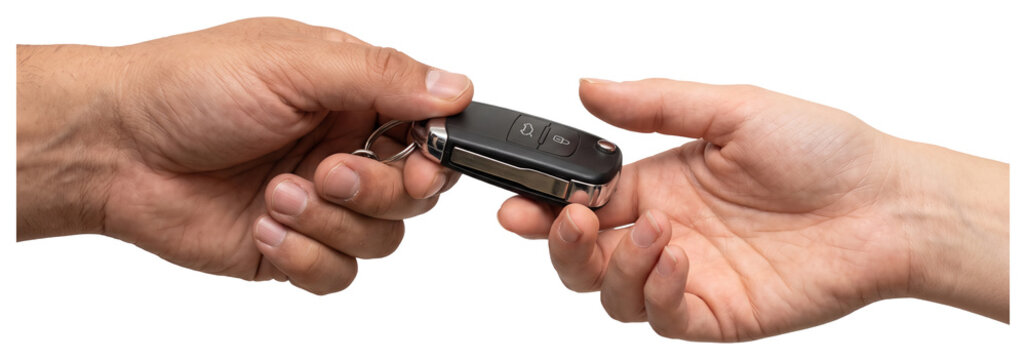 Hands exchanging a car key fob with key ring