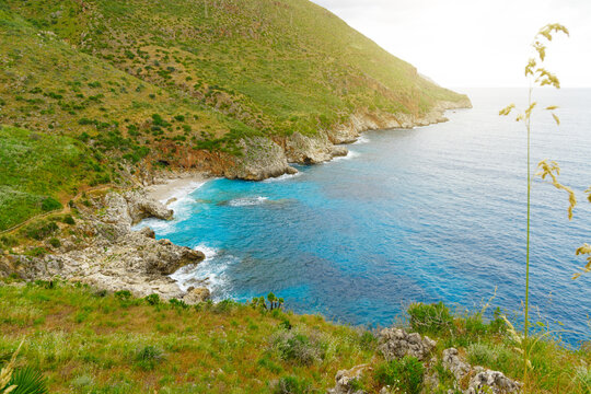 amazing travel place aerial view ocean shore line and green hill in sun shine light in the tranquil peaceful morning with cereal plant foreground