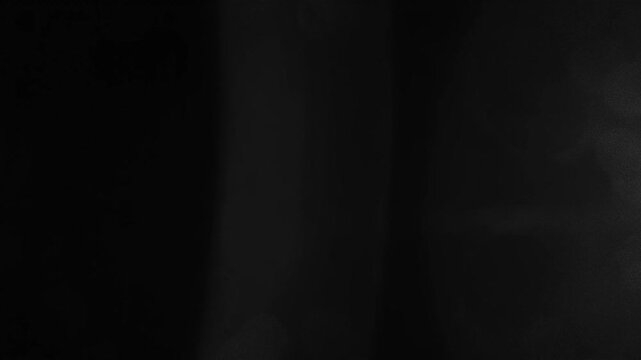 Abstract gray background with soft light flares and subtle circular textures