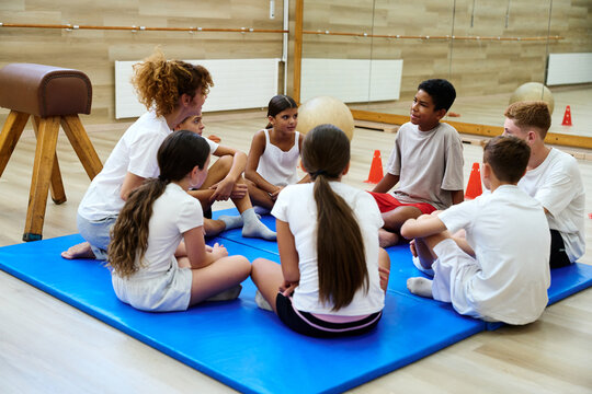 Teacher talking with students in physical education class