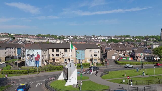Aerial view of the Free Derry Corner monument, surrounding residential streets, and local traffic in Londonderry, Northern Ireland, United Kingdom.