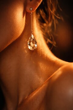 Extreme macro captures glamorous diamond earring dangling near model neckline