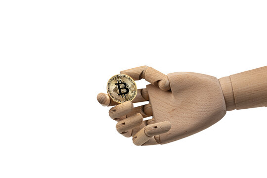 Wooden mannequin hand holding a golden Bitcoin coin isolated on a white background. Cryptocurrency, blockchain, digital finance, AI technology and investment concept with copy space.
