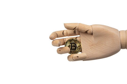 Wooden mannequin hand holding a Bitcoin coin isolated on white background. Cryptocurrency, digital finance, blockchain and investment concept with copy space.
