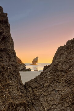 Low tide at Playa de Buelna Beach during a spectacular, fiery dawn with a rock-framed view of 'El Pic&oacute;n' limestone pinnacle. Llanes-Asturias-Spain-080
