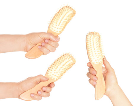 Set of hands holding bamboo comb, isolated on transparent background. Ideal for hair care, beauty, and sustainable projects