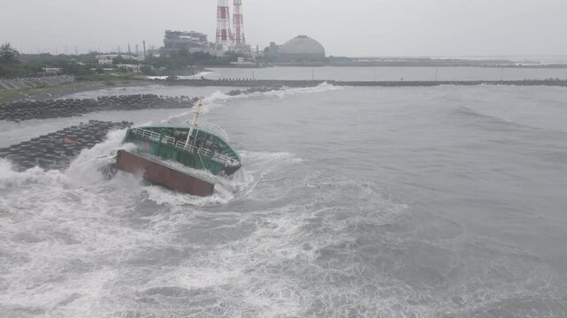 Storm Waves Break Over Shipwreck And Coastal Sea Defenses