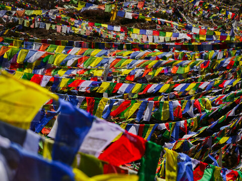 Colorful Tibetan prayer flags fluttering in the wind in the Himalayan mountains of Nepal