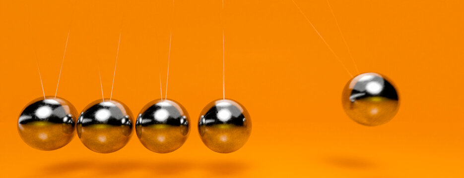 Newton's cradle balls in motion demonstrating kinetic energy transfer and momentum conservation