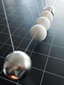 Newton's cradle balls demonstrating teamwork and momentum transfer in business