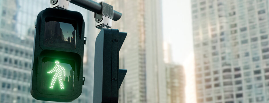 Green pedestrian signal illuminates the way for walkers in a bustling city