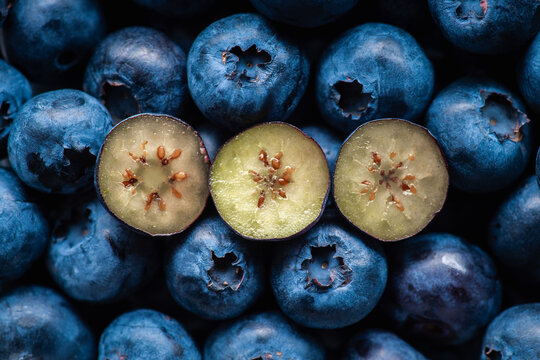 Fresh blueberries with one cut berry macro close up. Top view.