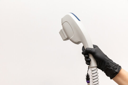 Aesthetic Laser Treatments concept. Doctor hand with laser device, white background. Innovative non-ablative fractional technology for skin photo rejuvenation. Cellular renewal, collagen synthesis