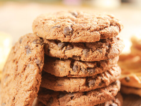 Close up uf chocolate cookies with chocochips that stacked, shows a texture with blurred background, Halloween and Christmas concept