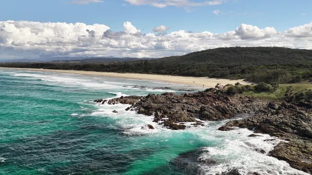 Aerial drone footage of surf rolling onto Hastings Point beach, Tweed Coast, NSW Australia