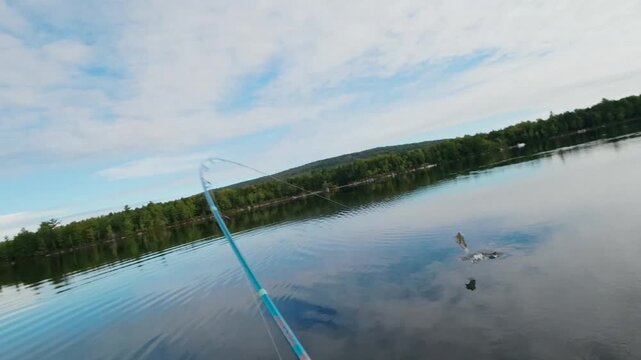 POV slow motion catching a small mouth bass on Egg Pond in Lincoln, ME 