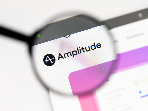 Milan, Italy 2026, 15 AGO Closeup of amplitude website page on a laptop screen. Focus on amplitude logo under a magnifying glass.