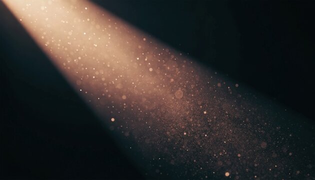 Golden spotlight with dust motes on a dark background