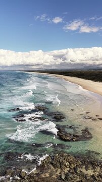 Hastings Point aerial drone footage over the headland, beach and turquoise water, Tweed Coast, NSW Australia - vertical video