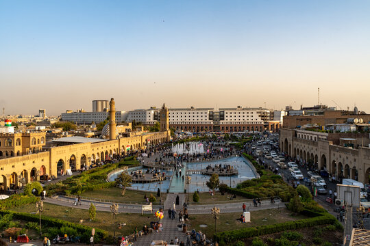 View of the historic Citadel of Erbil with its central fountain, bustling city square, and surrounding traditional architecture in Erbil, Erbil Governorate, Iraq.