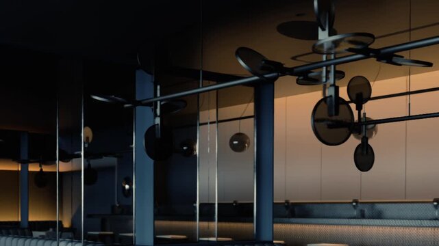 A kitchen area shows hanging utensils, pots, and pans. The light from the evening creates shadows and highlights on the surfaces. The space is organized and functional for cooking.