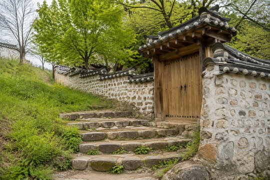 Rounded stone steps leading to a Korean village gate