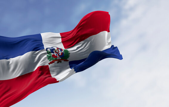 National flag of the Dominican Republic waving in the wind on a clear day