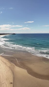 Maggies Beach aerial view of the beach, dunes and hinterland beyond, NSW Australia - vertical video