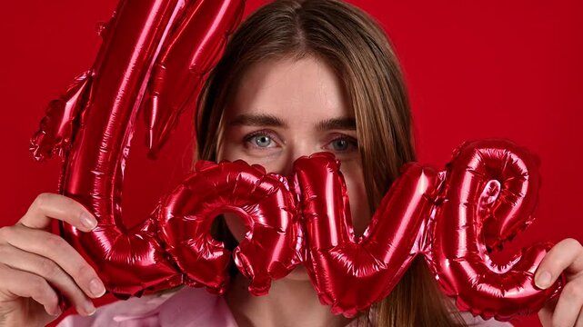 St Valentines concept. Happy smilimg Woman with love sign balloon