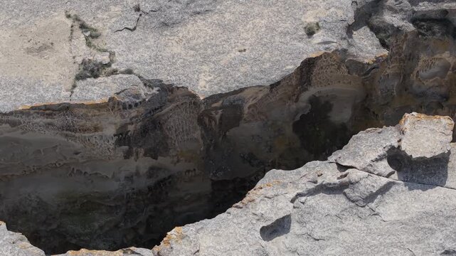 Aerial view of the rugged limestone canyon and deep sinkhole formations in the desert landscape of Mangistau, Mangystau Region, Kazakhstan.
