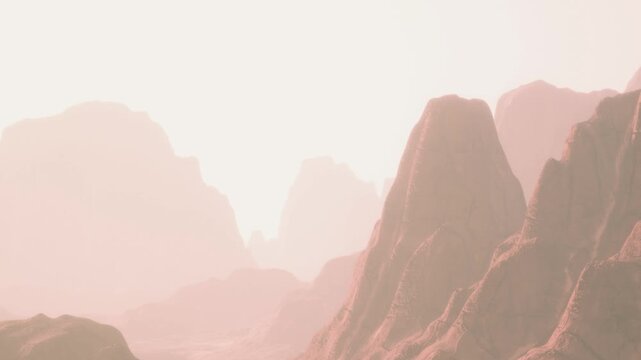The scene shows tall mountains under soft light at dawn. The sharp outlines of the rocks create a dramatic view. The sky is light with a warm tone giving a sense of early morning.