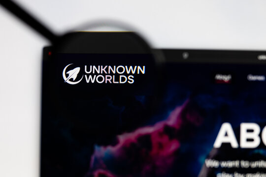 Milan, Italy 2026, 15 AGO Closeup of Unknown worlds website page on a laptop screen. Focus on Unknown worlds logo under a magnifying glass.