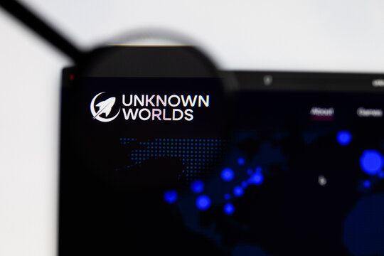 Milan, Italy 2026, 15 AGO Closeup of Unknown worlds website page on a laptop screen. Focus on Unknown worlds logo under a magnifying glass.