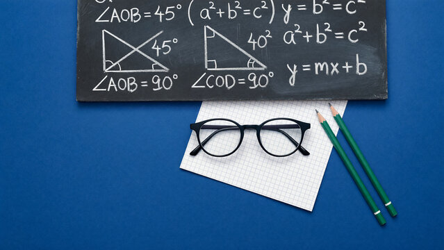 Math formula on chalkboard with eyeglasses near pencil, science education and academic knowledge